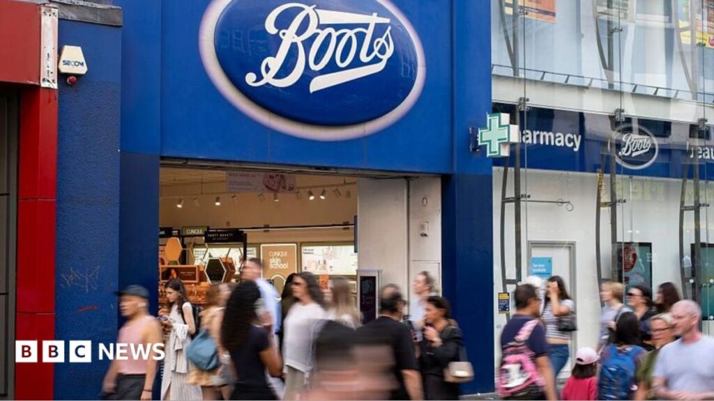 Shoppers walk by a Boots store in central London