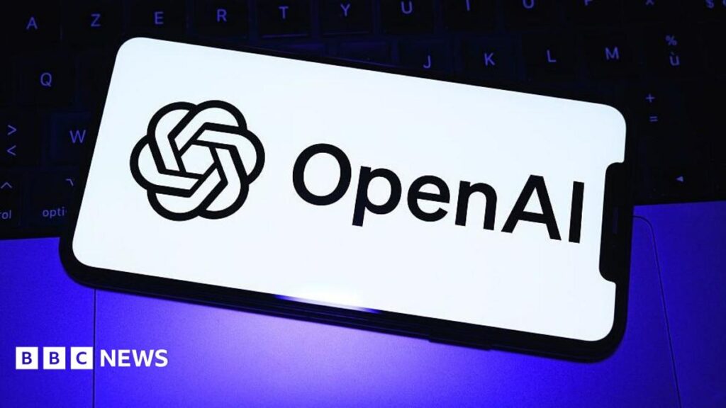 The OpenAI logo in black font on a white phone background over a purple light and black keyboard