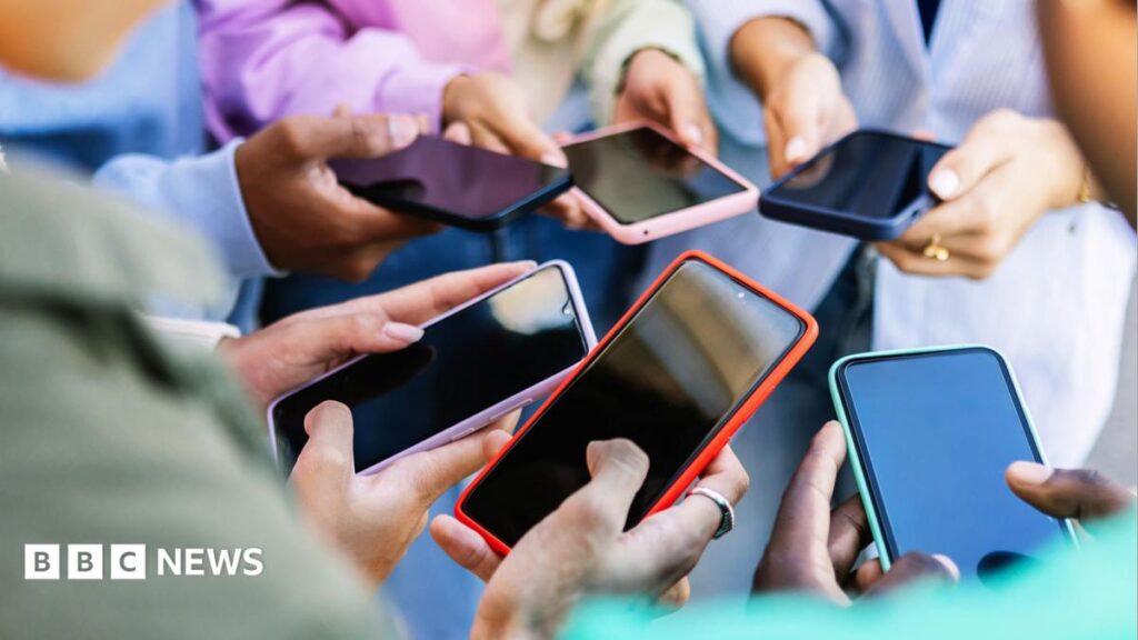 OpenAI says teen ChatGPT use limited but research finds it an ‘unacceptable risk’ A group of young people holing their smartphones.